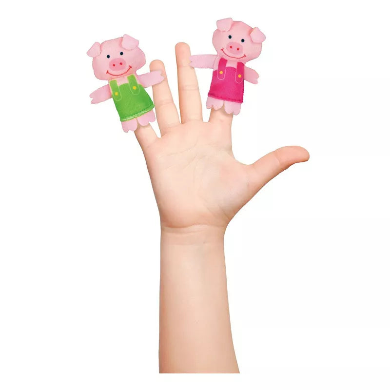 a hand with two Fiesta Crafts Big Bad Wolf & 3 Little Pigs Puppet Set in the shape of pigs.