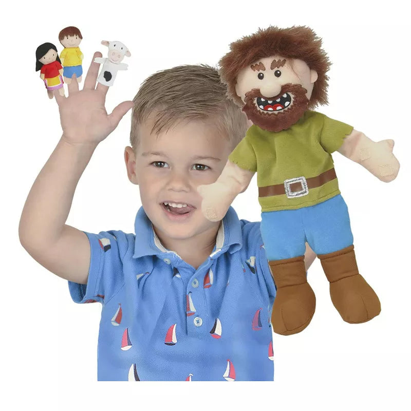 A young boy is holding up the Fiesta Crafts Jack & The Beanstalk Puppet Set.