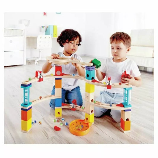 A couple of kids playing with the Hape Castle Escape.