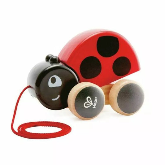 The Hape Pull along Lady bug is a wooden toy with a ladybug on it.