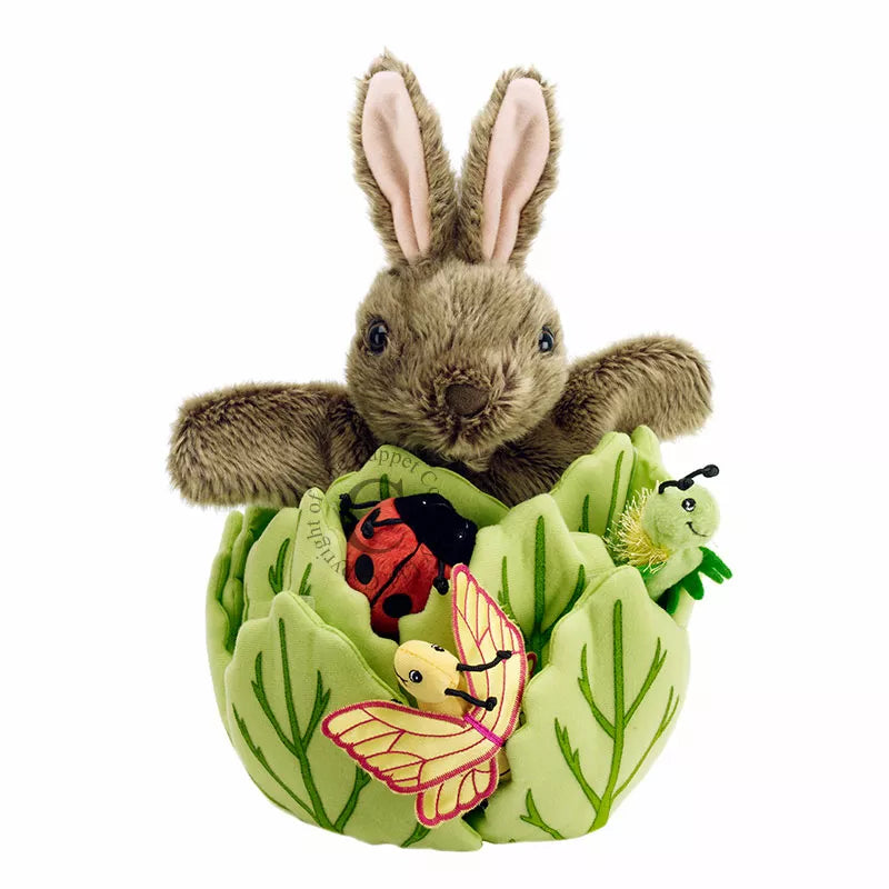 The Puppet Company Hide-Away Rabbit is sitting in a decorative bowl.