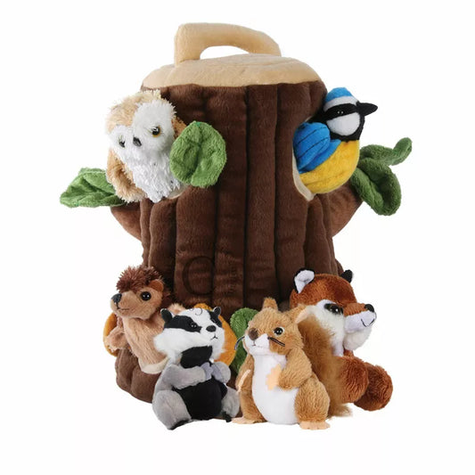 A group of The Puppet Company Hide Away Tree House stuffed animals sitting on top of a tree stump.