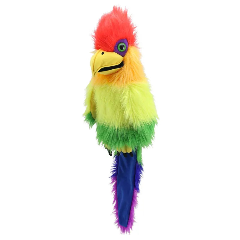 The Puppet Company Rainbow Bird Hand Puppet features vibrant feathers in red, orange, yellow, green, blue, and purple. With expressive eyes and a yellow beak, this colorful parrot puppet has a primarily yellow and green body. Its tail feathers are blue and purple, set against a plain white background.