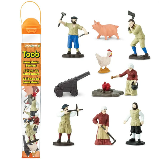 A collection of TOOB® Figurines Jamestown Settlers representing, including figures of men, women, a pig, a chicken, and a cannon with accessories. Packaged in an orange labeled container.