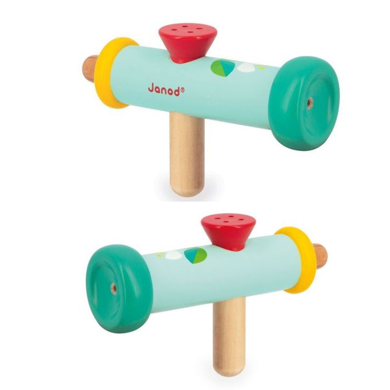 Two views of a colorful Janod Gioia Wooden Trumpet by Janod. The trumpet, perfect as a 2 year old toy, features a green body with a yellow ring on one end, a green disc on the other, and is adorned with geometric shapes. It has a red mouthpiece on top and a wooden handle underneath, ideal for developmental play.