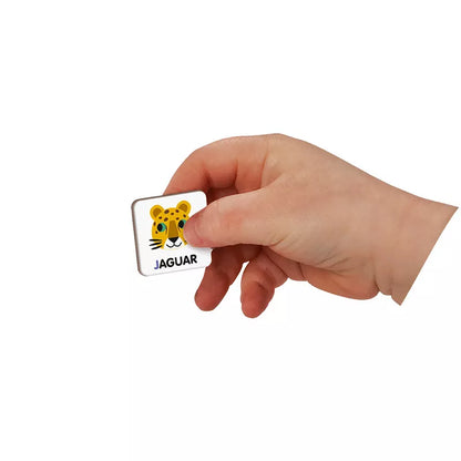 A hand holding a sticker with a picture of a cat.