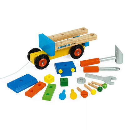 A Janod Brico'Kids DIY Truck with construction tools and a hammer.