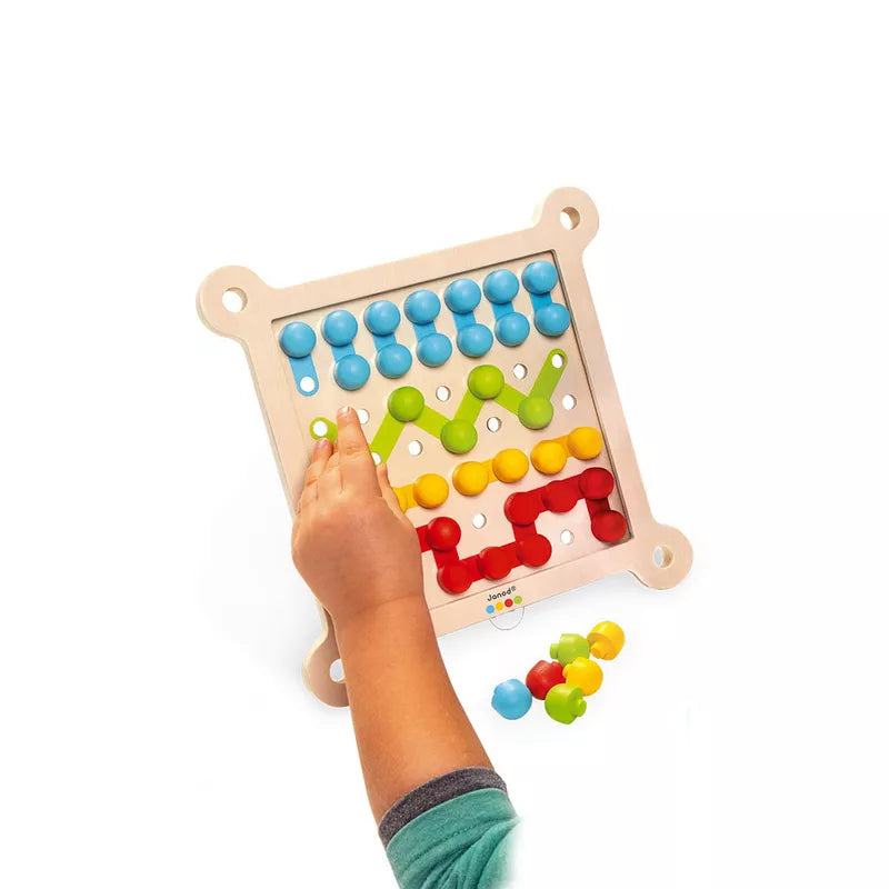 A child playing with a Janod Lacing game.