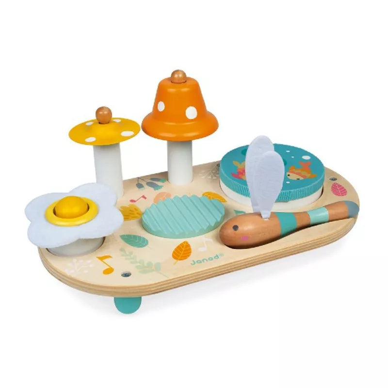 A Janod Pure Musical Table with various toys on it.