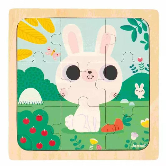 A Janod White Rabbit Puzzle toy with a bunny and carrots.