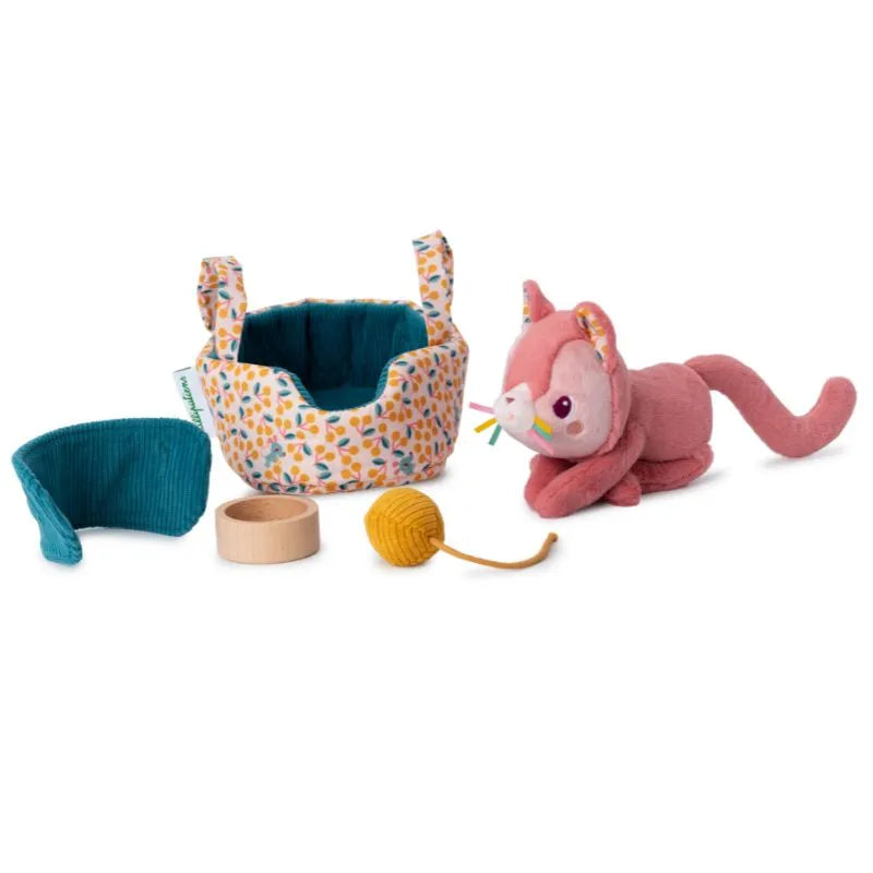 The Lilliputiens I'm Exploring Jeanne Cat With Basket is a delightful baby gift set, featuring a plush pink cat toy, a colorful leaf-patterned basket, a yellow yarn ball, and a wooden ring—perfect as an ideal first toy companion for any baby.