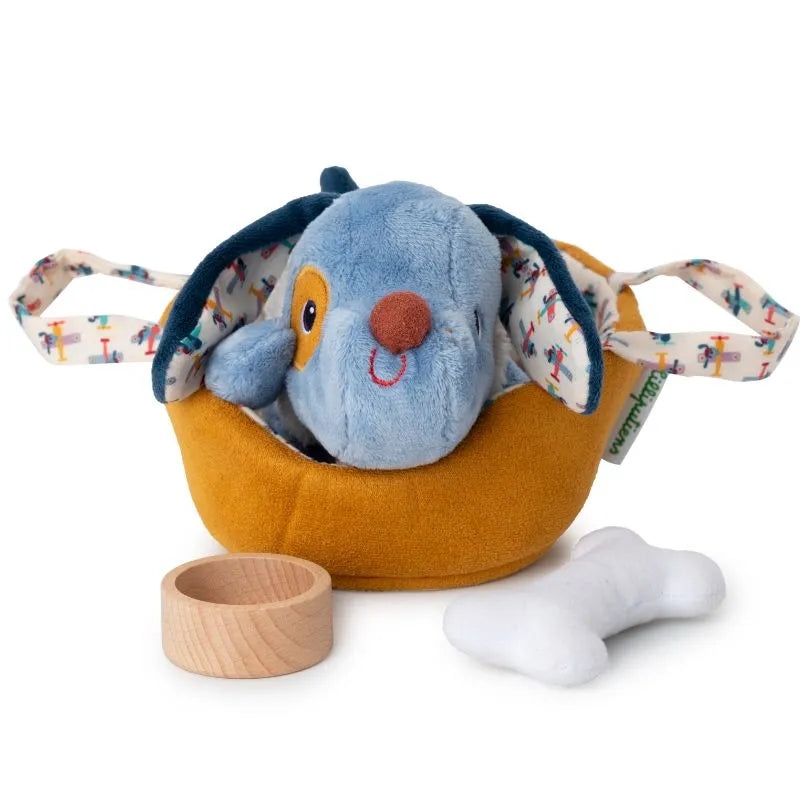 The Lilliputiens "I'm Exploring Jules Dog With Basket" features a plush dog with floppy ears seated in a small yellow basket with fabric handles. It includes a colorful wooden ring and a small white plush bone, making it the perfect baby gift.