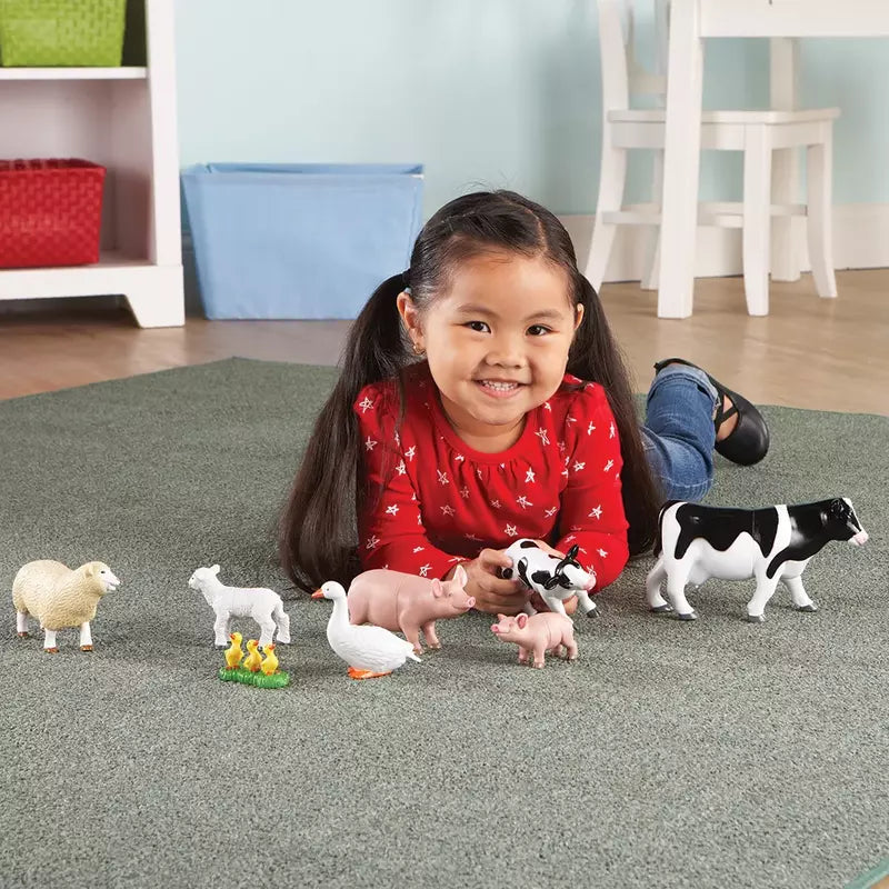 A toddler playing on the floor with Learning Resources Jumbo Farm Animals - Mommas and Babies.