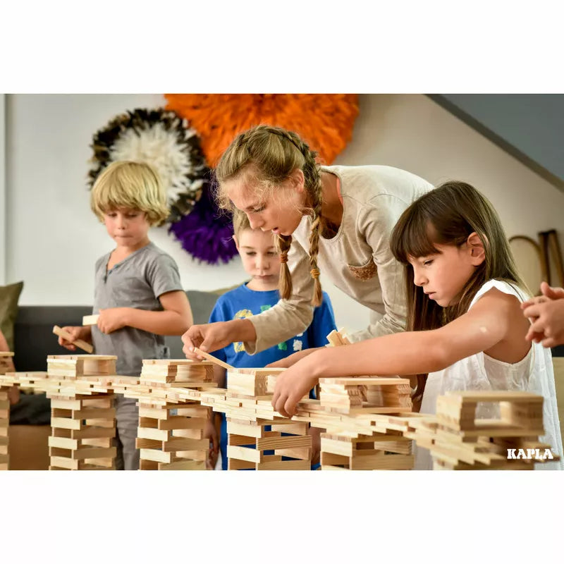 A woman and two children playing with KAPLA® Construction 200 Planks.