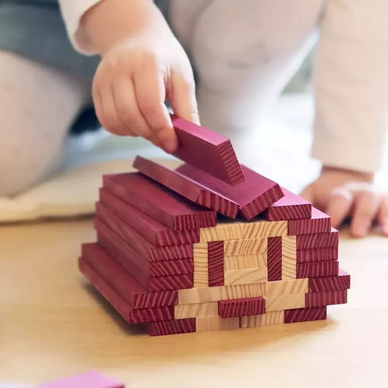 A child playing with KAPLA® 40 Coloured Planks Purple.