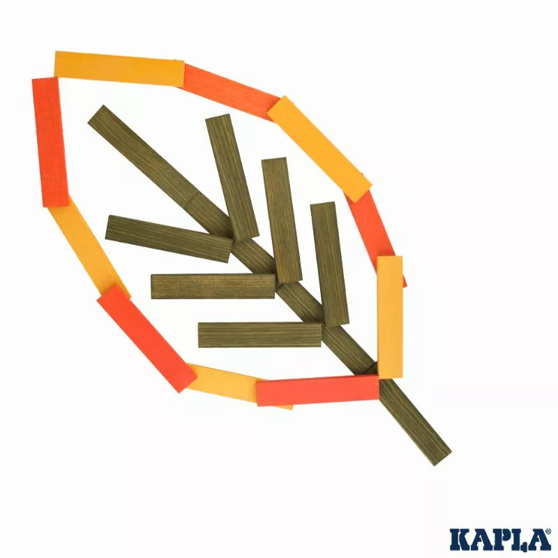 KAPLA® 200 Autumn Box blocks arranged in a pattern resembling a leaf, combining orange and natural-colored pieces, on a white background. The logo "Kapla" is visible on this construction toy.