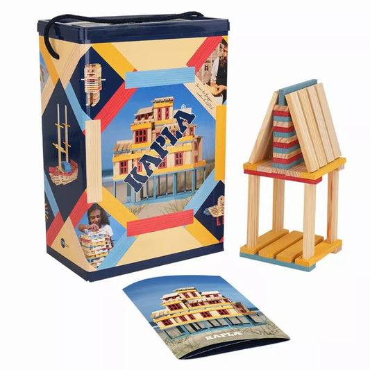 Sentence with product name: Colorful wooden KAPLA® 200 Summer Box designed to inspire open-ended play, creativity, and architecture awareness in children, displayed with packaging and an example of a constructed building model.