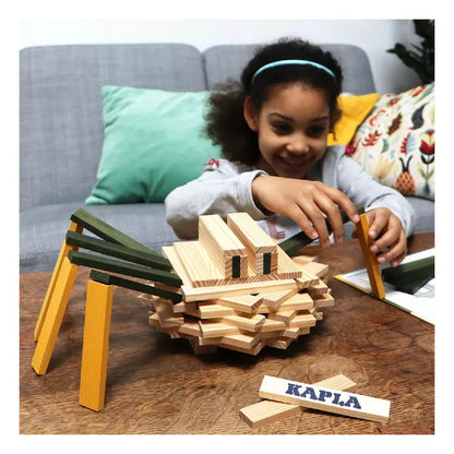 A young girl playing with a KAPLA® Construction Spider Case.