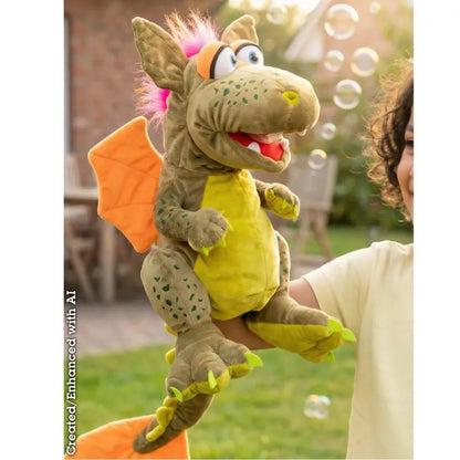 A person holds Rocco The Dragon Hand Puppet—featuring orange wings, pink hair, and big eyes—outdoors as bubbles float by, creating a playful children’s toy scene.