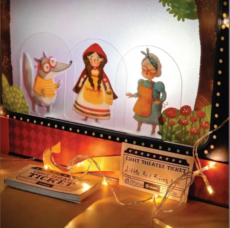 Experience the magic of Shadow Theatre – The Amazing Light Theatre of Wonders, featuring paper puppets (wolf, Little Red Riding Hood, grandmother) and glowing string lights for an enchanting “Little Red Riding Hood” shadow play storytelling toy.