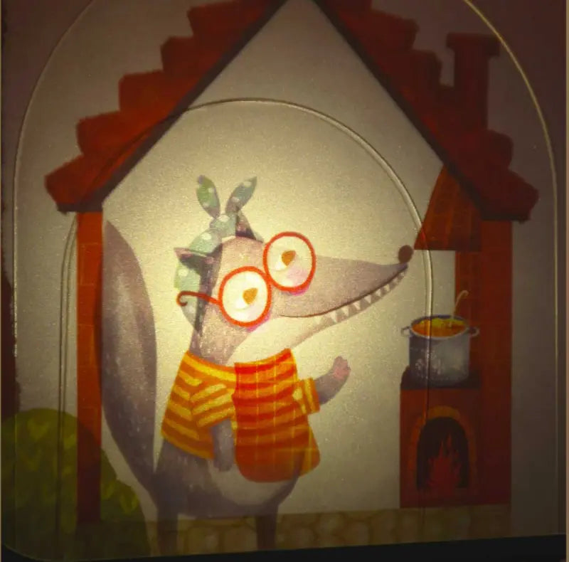 A cartoon wolf with glasses, a green headscarf, and a yellow-striped shirt stands in a house, smiling at a pot over the stove—ideal for imaginative play with Shadow Theatre – The Amazing Light Theatre of Wonders.