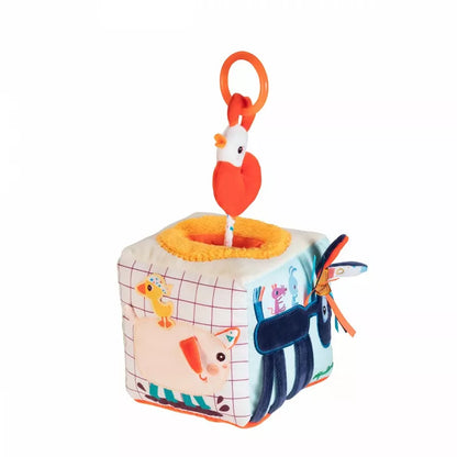 A small Lilliputiens Farm Activity Sound Cube toy with an animal on top of it.