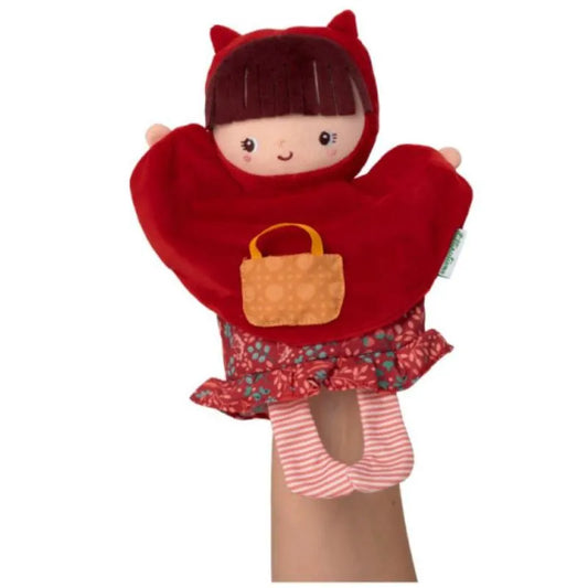 The Lilliputiens Red Riding Hood Handpuppet showcases a plush doll adorned in a red hooded cape, a patterned dress with a red and blue floral skirt, and pink striped tights. Ideal for imaginative play, it also includes a small brown handbag and features a cheerful facial expression. Furthermore, it's machine washable!