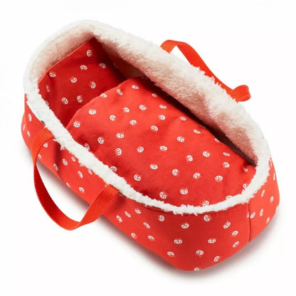 a Lilliputiens Babydoll Basket with a white polka dot pattern.