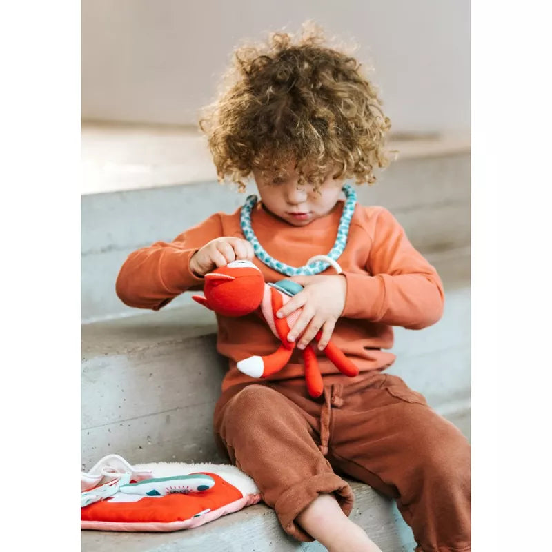 A young child playing with a Lilliputiens Little Doctor Bag.