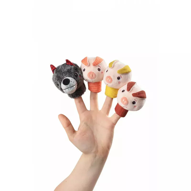 A hand adorned with four Lilliputiens Louis The Wolf And The 3 Little Pigs finger puppets, ready to tell a classic tale.