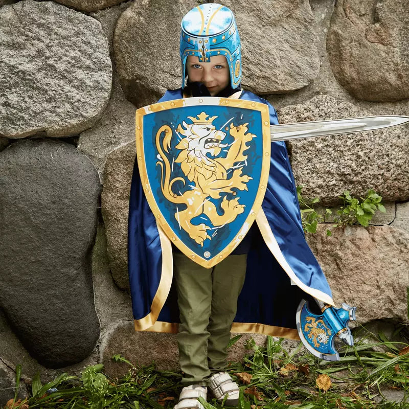 a boy dressed as a knight with a Liontouch Noble Set Sword, Shield & Axe.