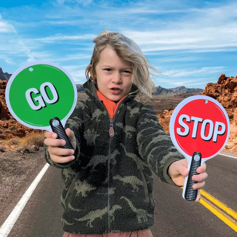 a child holding two Liontouch Stop & Go Signs.