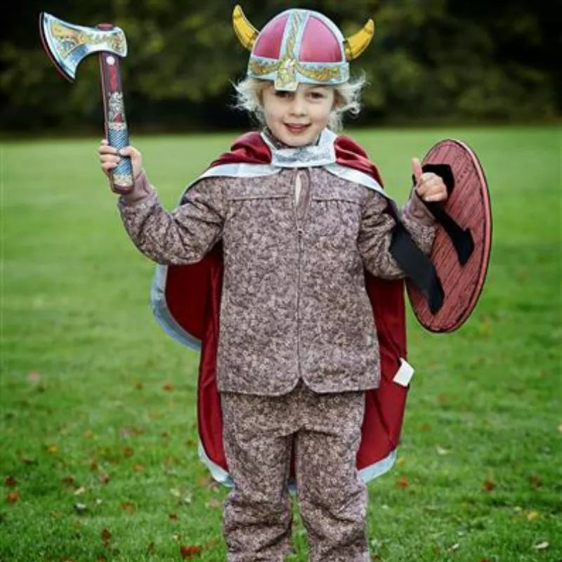 A little boy in a Viking costume holding an axe, wearing the Liontouch Viking Cape.