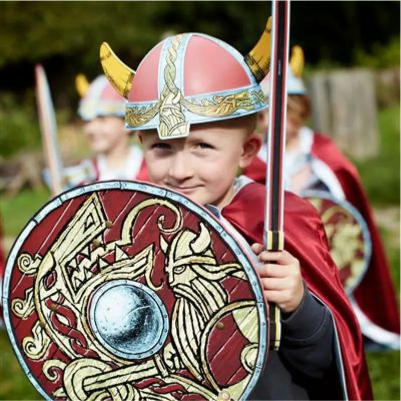 A group of children engaged in pretend play as vikings, holding shields and wearing Liontouch Viking Helmets for added safety.