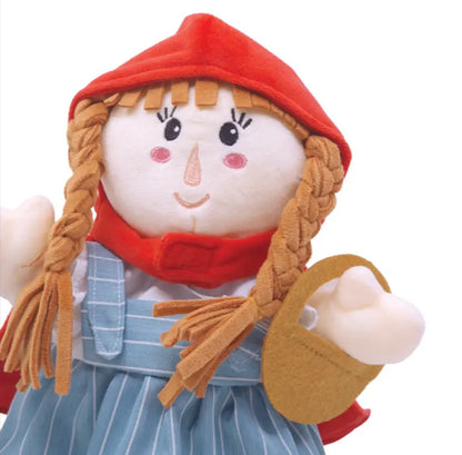 The Hand Puppet Little Red Riding Hood features braided blonde hair, a red hood, blue striped dress, rosy cheeks, and a brown felt basket—ideal for imaginative play and storytelling.