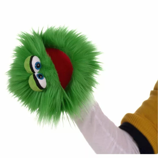 A person's hand wearing a Living Puppets Blappermouth Hand Puppet with bright green fur, big googly eyes, and a red mouth, against a white background.