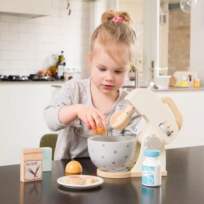 A little girl mixing a bowl with a New Classic Toys Mixer Set White.