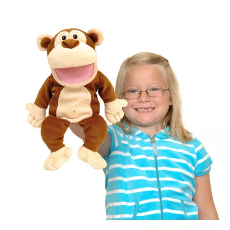 A little girl holding a Fiesta Crafts Monkey Hand Puppet and smiling.