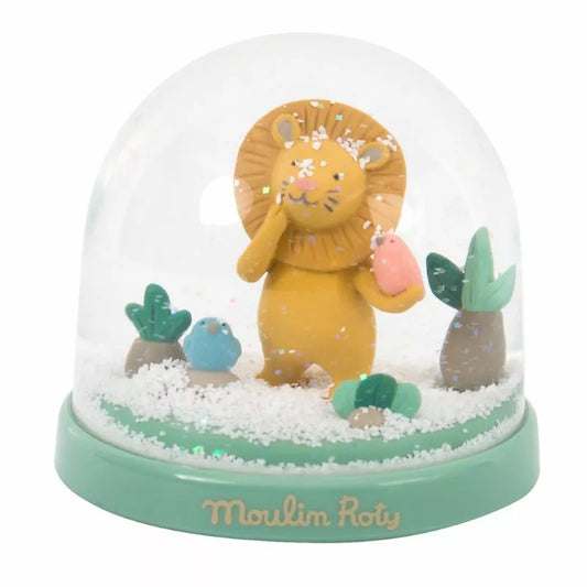 A Moulin Roty Snow Globe Under my Baobab with a lion inside of it.