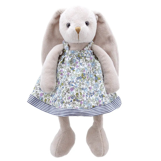A **Wilberry Friend Mrs Rabbit**, affectionately named Mrs. Rabbit, stands upright in a floral dress with blue and green patterns and a striped hem. This light gray rabbit features long floppy ears and looks forward, made from high quality materials for a truly soft toy experience.