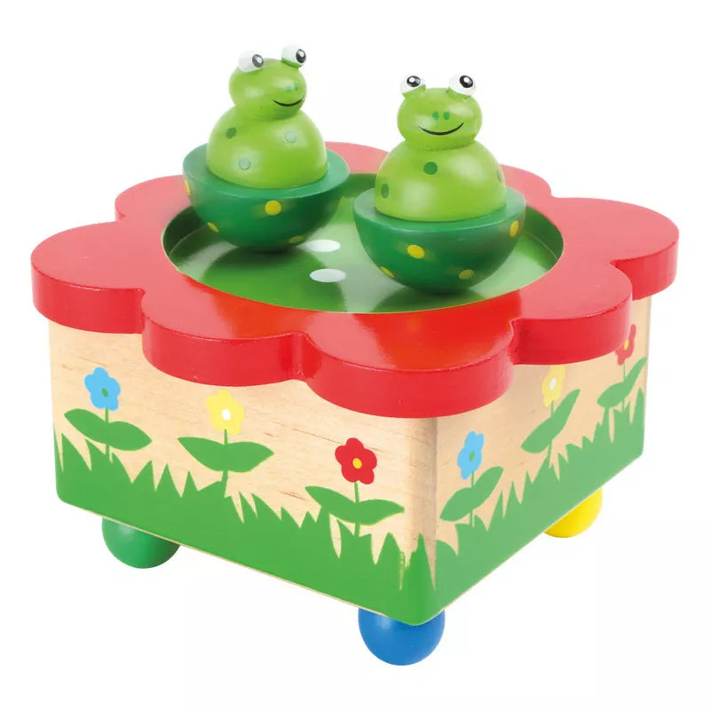 A Music Box Frog Pond with two frogs on top of it.