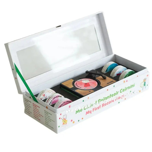 A white box with a clear lid holds a Mini Gramophone, plus colorful tape rolls. Labeled “Mini Gramophone Box Set” in English and Irish, it’s perfect for introducing kids to traditional Irish songs.