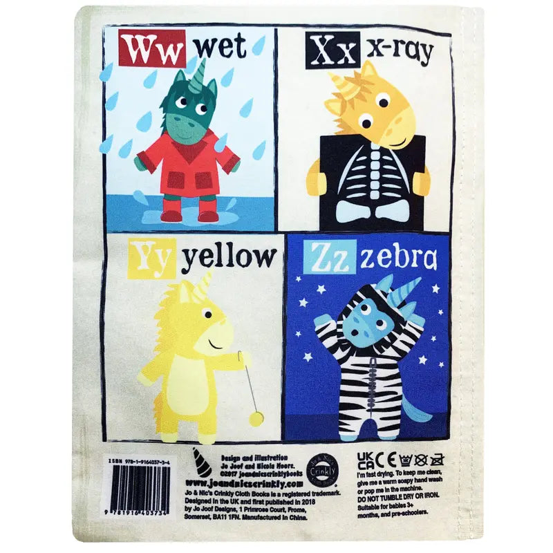 A page from Crinkly Cloth Book Unicorns shows four squares: “Ww wet” (green animal in raincoat), “Xx x-ray” (yellow animal with x-ray), “Yy yellow” (yellow animal with yo-yo), and “Zz zebra” (zebra costume).