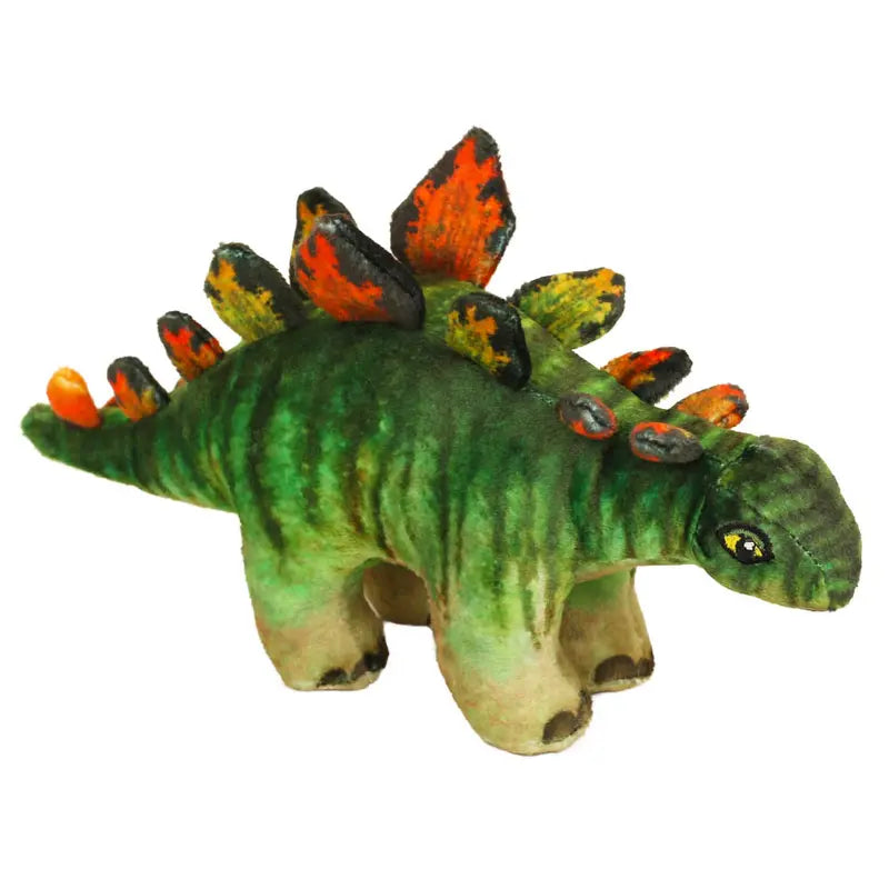 The Natural History Museum Small Stegosaurus Soft Toy is a green plush dinosaur with orange and black plates, four legs, and a friendly face—ideal for young explorers or fans of the museum.