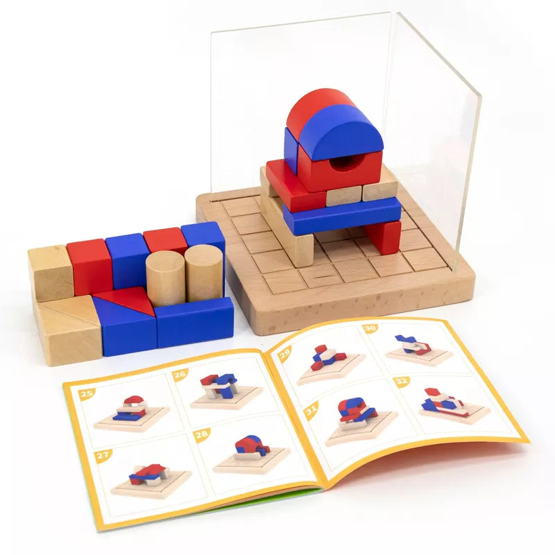 The 3D Block Building Game features a wooden brain-teasing toy set with pieces in red, blue, and natural wood colors arranged on a wooden grid board. The set includes various shapes such as cylinders and cubes that enhance spatial awareness. Accompanying the blocks is an instruction booklet open to show diagrams of different structures for problem-solving.