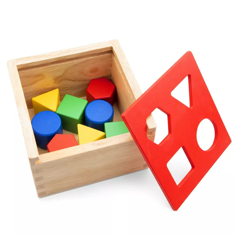 A wooden box filled with New Classic Toys Shape Sorting Cube.