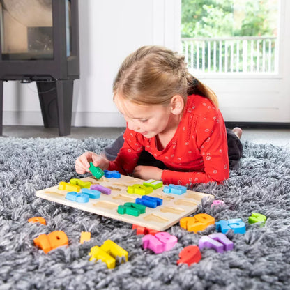 A little girl playing with the New Classic Toys Number Puzzle on the floor.