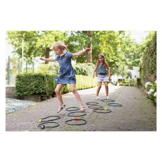 Two young girls playing Buitenspeel Hopscotch.
