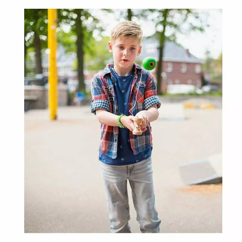 A young boy is playing with a Buitenspeel Kendama Skill Toy.
