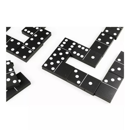 A set of Black and White Dominoes laying on top of each other.